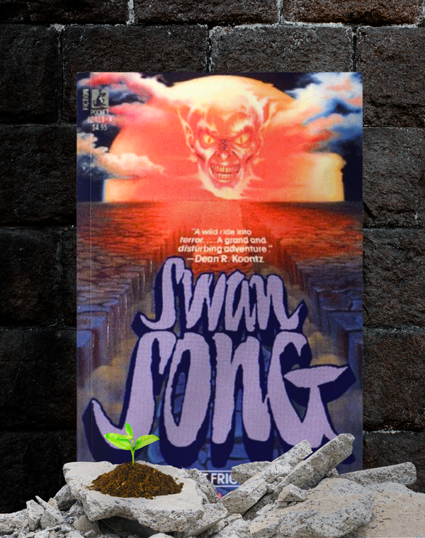 Vintage copy of Swan Song stands upright against a brick wall, surrounded by rubble and a tiny green sprout growing from the dirt.